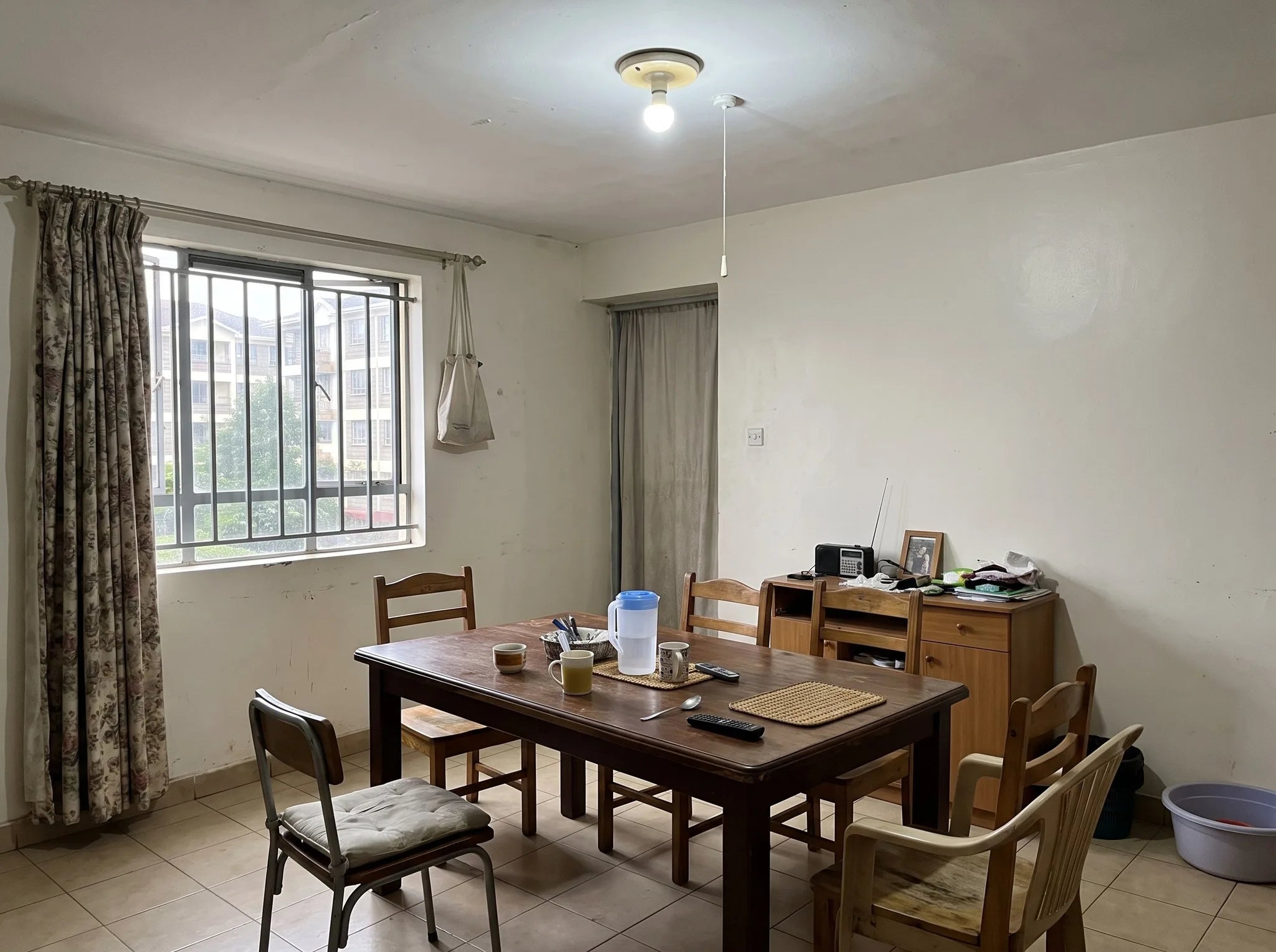 Dining area with a table and a bare ceiling bulb